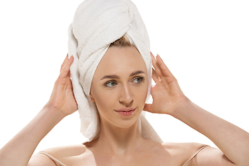 Image showing Beauty Day. Woman wearing towel doing her daily skincare routine. Portrait isolated on white studio background