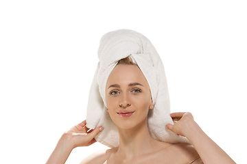 Image showing Beauty Day. Woman wearing towel doing her daily skincare routine. Portrait isolated on white studio background