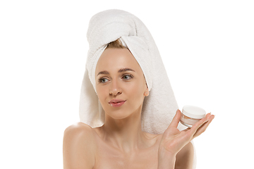 Image showing Beauty Day. Woman wearing towel doing her daily skincare routine. Portrait isolated on white studio background