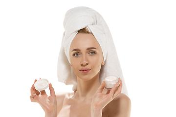 Image showing Beauty Day. Woman wearing towel doing her daily skincare routine. Portrait isolated on white studio background