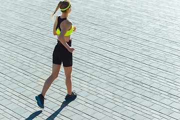 Image showing Female runner, athlete training outdoors in summer\'s sunny day.