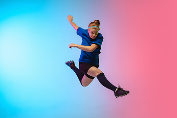 Image showing Female soccer, football player training in action isolated on gradient studio background in neon light