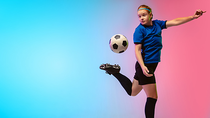 Image showing Female soccer, football player training in action isolated on gradient studio background in neon light