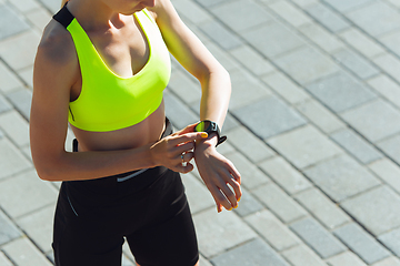 Image showing Female runner, athlete training outdoors in summer\'s sunny day.