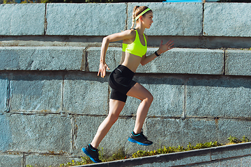 Image showing Female runner, athlete training outdoors in summer\'s sunny day.