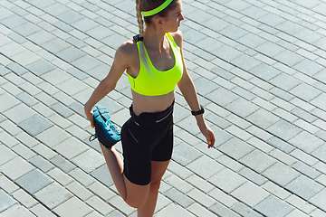 Image showing Female runner, athlete training outdoors in summer\'s sunny day.