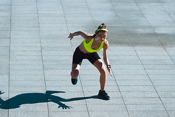 Image showing Female runner, athlete training outdoors in summer\'s sunny day.