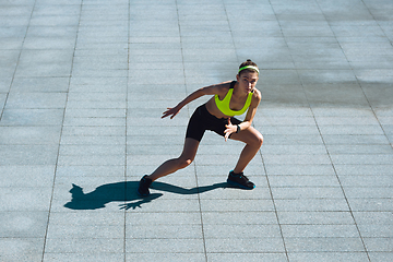 Image showing Female runner, athlete training outdoors in summer\'s sunny day.