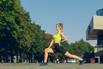 Image showing Female runner, athlete training outdoors in summer\'s sunny day.