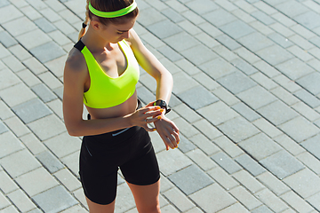 Image showing Female runner, athlete training outdoors in summer\'s sunny day.