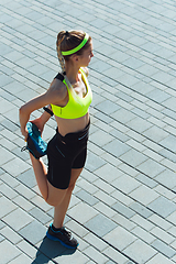 Image showing Female runner, athlete training outdoors in summer\'s sunny day.