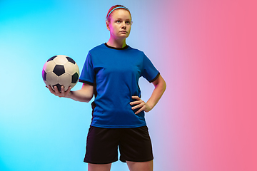 Image showing Female soccer, football player training in action isolated on gradient studio background in neon light