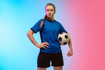 Image showing Female soccer, football player training in action isolated on gradient studio background in neon light