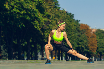 Image showing Female runner, athlete training outdoors in summer\'s sunny day.