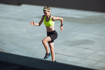 Image showing Female runner, athlete training outdoors in summer\'s sunny day.