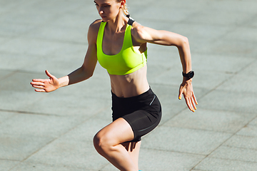 Image showing Female runner, athlete training outdoors in summer\'s sunny day.