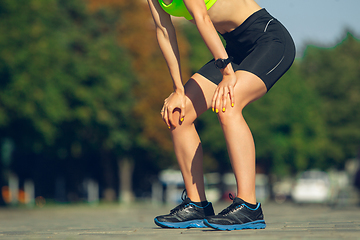 Image showing Female runner, athlete training outdoors in summer\'s sunny day.