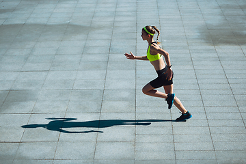 Image showing Female runner, athlete training outdoors in summer\'s sunny day.