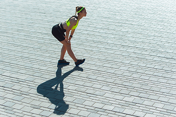 Image showing Female runner, athlete training outdoors in summer\'s sunny day.