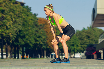 Image showing Female runner, athlete training outdoors in summer\'s sunny day.