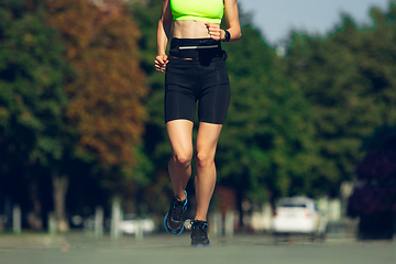Image showing Female runner, athlete training outdoors in summer\'s sunny day.