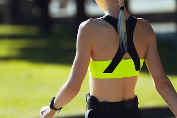 Image showing Female runner, athlete training outdoors in summer\'s sunny day.