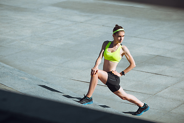 Image showing Female runner, athlete training outdoors in summer\'s sunny day.