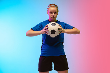 Image showing Female soccer, football player training in action isolated on gradient studio background in neon light