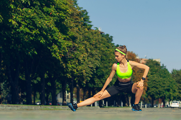 Image showing Female runner, athlete training outdoors in summer\'s sunny day.