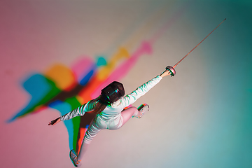 Image showing Teen girl in fencing costume with sword in hand on gradient background with neon light, top view