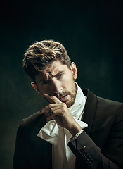 Image showing Young man as Dorian Gray on dark background. Retro style, comparison of eras concept.