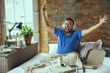 Image showing Lazy man living the whole life in his bed surrounded with messy