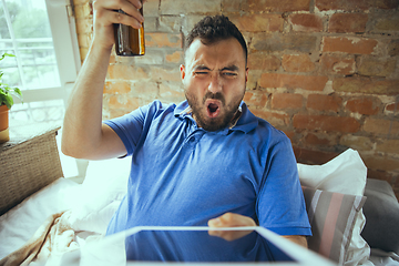 Image showing Lazy man living the whole life in his bed surrounded with messy