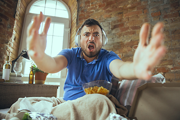 Image showing Lazy man living the whole life in his bed surrounded with messy