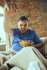 Image showing Lazy man living the whole life in his bed surrounded with messy