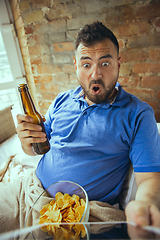 Image showing Lazy man living the whole life in his bed surrounded with messy