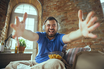 Image showing Lazy man living the whole life in his bed surrounded with messy