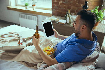 Image showing Lazy man living the whole life in his bed surrounded with messy