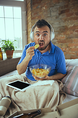 Image showing Lazy man living the whole life in his bed surrounded with messy