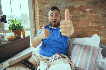 Image showing Lazy man living the whole life in his bed surrounded with messy