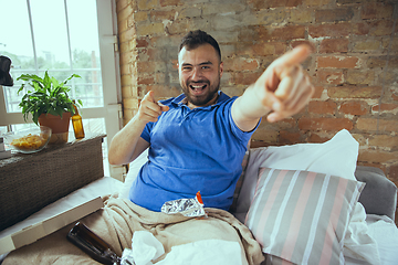 Image showing Lazy man living the whole life in his bed surrounded with messy