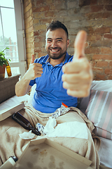 Image showing Lazy man living the whole life in his bed surrounded with messy