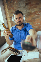 Image showing Lazy man living the whole life in his bed surrounded with messy