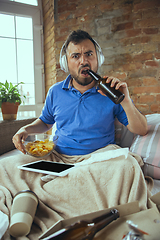 Image showing Lazy man living the whole life in his bed surrounded with messy