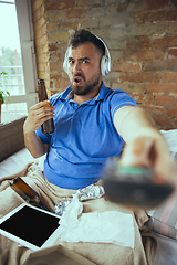 Image showing Lazy man living the whole life in his bed surrounded with messy