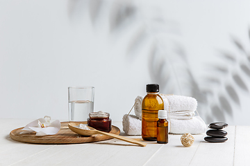 Image showing Beautiful spa composition on massage table in wellness center, copyspace, leaves\' shadow