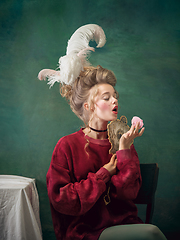 Image showing Young woman as Marie Antoinette on dark background. Retro style, comparison of eras concept.