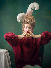 Image showing Young woman as Marie Antoinette on dark background. Retro style, comparison of eras concept.