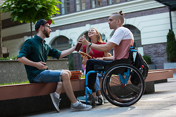 Image showing Group of friends taking a stroll on city\'s street in summer day