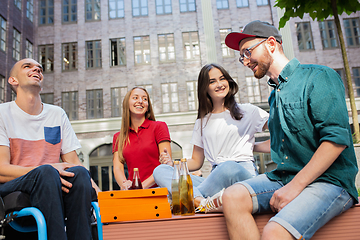 Image showing Group of friends taking a stroll on city\'s street in summer day